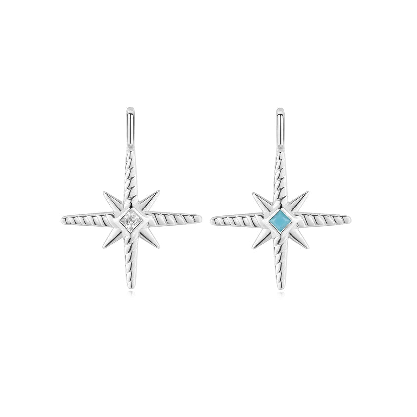 Star-shaped earrings with a central gemstone on a white background